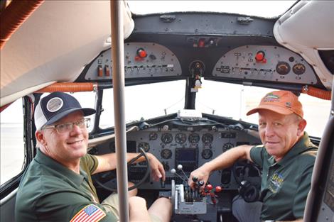 Miss Montana pilots Art Dykstra and Bryan Douglass pose for a photo in the cockpit.