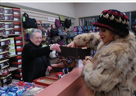 Nila Anderson draws a ticket from the box of eligible shoppers. Winners of the four holiday boxes won $500 worth of gift certificates. 