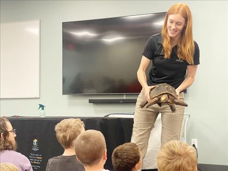 Jessi Castañeda of Animal Wonders Inc. introduces her animal ambassadors to attendees of a July 25 program at the North Lake County Public Library. Castañeda holds a red-footed tortoise named Titus.