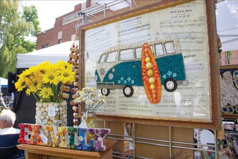 A beaded and buttoned Volkswagen van on top of music sheets was on display at the 53rd annual Courthouse Art Festival.