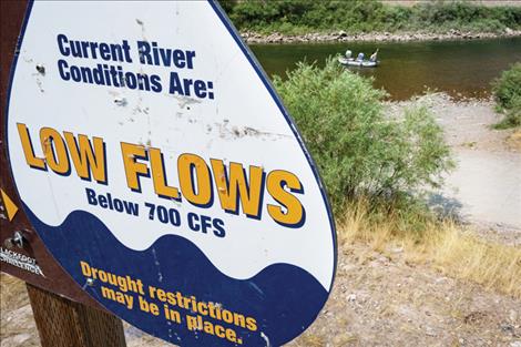 A sign near a fishing access point on the Blackfoot River warns users of low flows. The river is experiencing record-setting low streamflow conditions due to low snowpack in the Blackfoot River watershed.  