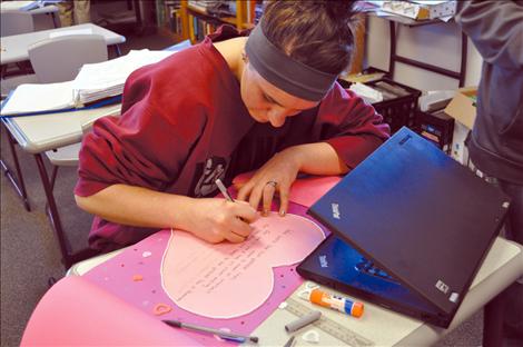 Lisa Cox decorates a geometry-themed valentine at Charlo High School. 