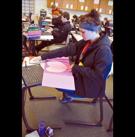 Lisa Cox decorates a geometry-themed valentine at Charlo High School. 