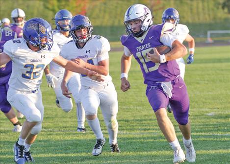 Polson  Pirate quarterback Holden  Emerson  rushes the ball down the field during a  Sept. 6 home game against the Libby Loggers. Polson defeated Libby 38-8.