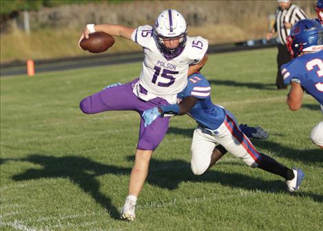 Polson halfback Shaedon Perry shakes off would-be Bigfork Viking tacklers during an Aug. 30 home football game. Bigfork prevailed over Polson 38-3.