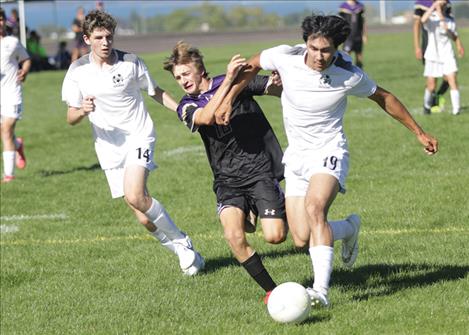 Polson’s Jackson Bontadelli battles Park County players for control of the ball.