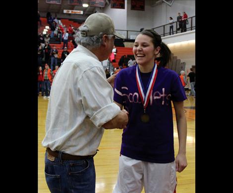 Anthony Plant congratulates Whitney Malatare for earning a sportsmanship award.