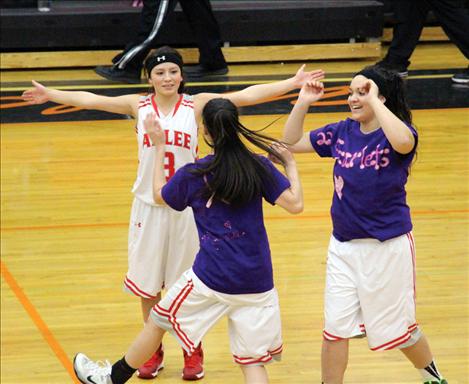 Arlee Scarlets Becca Whitesell, Violet Pablo and Alicia Camel celebrate after winning the first-place trophy.