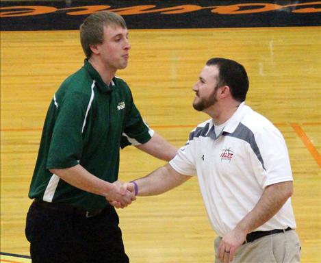 Arlee girls' coach Tyler Hurley shakes the hand of Bill Stockton.