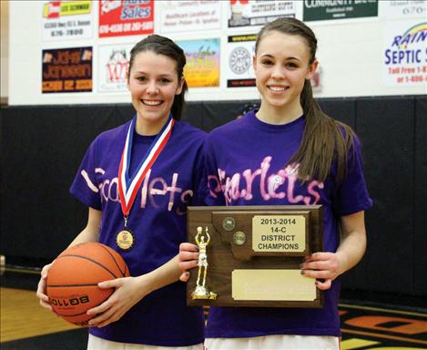 Arlee seniors Whitney Malatare and Alexi Shick hold the first place trophy.