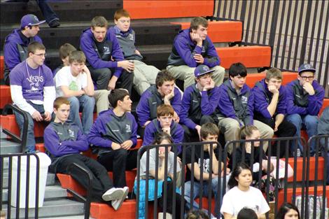 The Charlo Viking basketball team waits in the bleacher during the district tournament in Ronan.