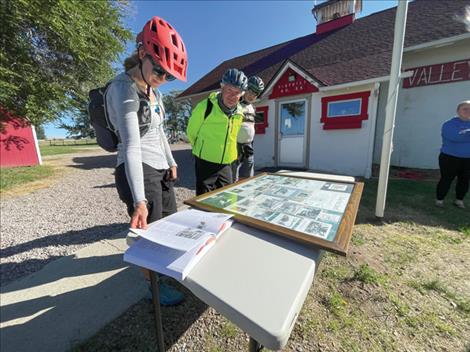 Cyclists learn about the history of Valley View School at the second stop of the 2024 route.