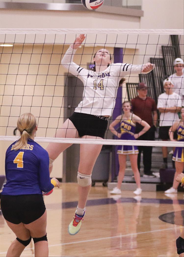 McKenna Corley winds up to hit the ball over the net.