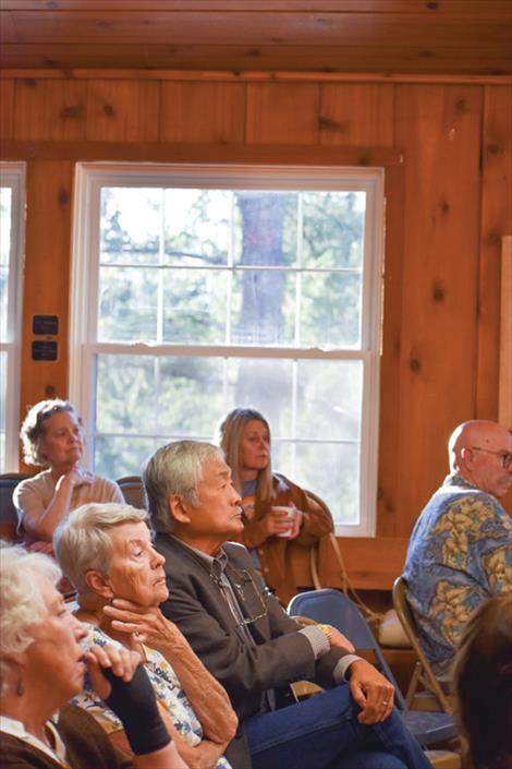 Audience members listen to local candidates speak on a variety of issues.