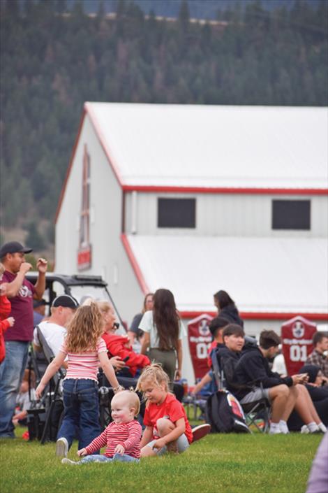 Even the youngest homecoming football game fans donned red and white to show their school spirit.