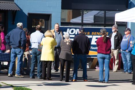 Sen. Tester speaks with voters outside the the Lake County Democrat headquarters on Main Street in Polson on Sunday, Oct. 6.