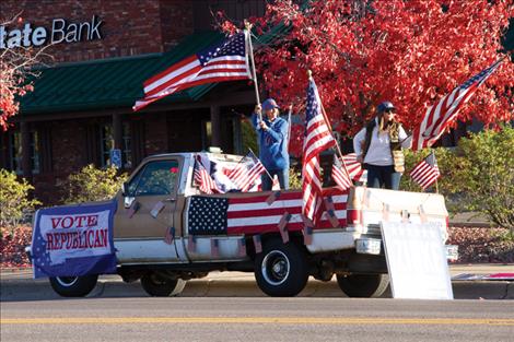 Lake County Republicans wave flags during a visit from Representative Ryan Zinke in his campaign to retain his seat in the U.S. House of Representatives. 