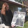 Emilie McGrath holds a photo of her grandfather in his WWII uniform.