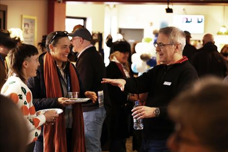 Filmmaker Hannah Everett (far left) and her mother converse with FLIC Director David W. King at the 2024 opening party last February. 