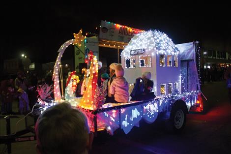 The Providence St. Joseph Medical Center float, decorated with a nativity scene and hospital, makes its way down Main Street.