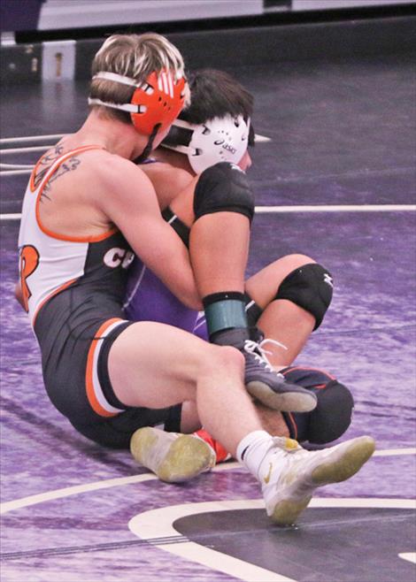 A Ronan wrestler takes on a  Mission- Charlo opponent during the Dec. 6 Owen  Invitational.