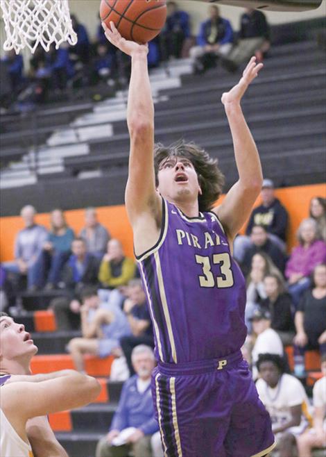 Polson Pirate basketball player Cason Graham goes in for a layup during a Dec. 14 game against Fergus.