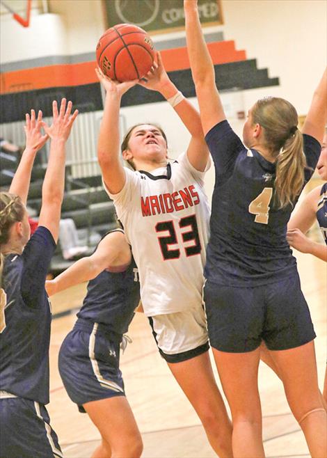 A Ronan Maiden shoots an inside layup in a sea of opponents. 