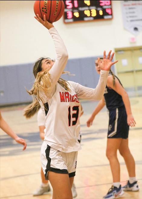 A Ronan Maiden basketball player puts up a layup in a game against Timberlake High School. The Maidens defeated Corvallis 40-18 in a Dec. 17 game played at home.