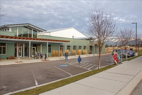 Students get off the bus after school and walk into the Boys and Girls Club, Polson site.