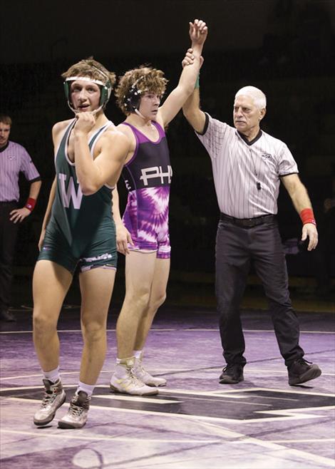 Polson wrestler Daniel O’Roake wins by pin at the Jan. 16 duals against Whitefish. Browning canceled their trip to compete in Polson due to high winds.