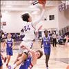 Polson boys basketball player Malakai Curley, drives to the basket, is blocked, scores and then makes a free throw.