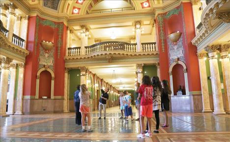 With the guidance of a Montana Historical Society tour guide, children learn about the history, art and architecture of the capitol building in Helena.