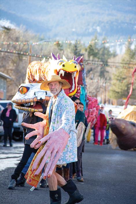 With giant puppet hands Paul Stelter leads the 2025 Lunar New Year parade down Main Street in Hot Springs.