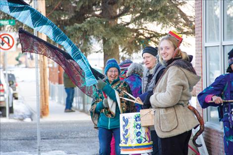 Flag wavers and members of the bucket brigade practice their moves before the parade start.