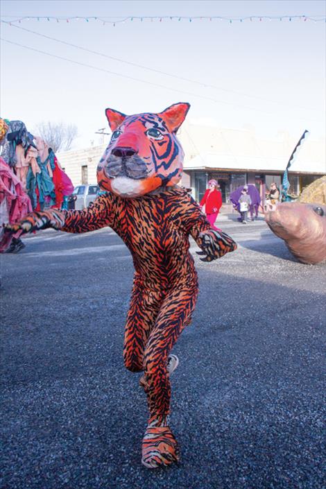 A tiger dances its way down Main Street during the parade