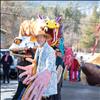 With giant puppet hands Paul Stelter leads the 2025 Lunar New Year parade down Main Street in Hot Springs.