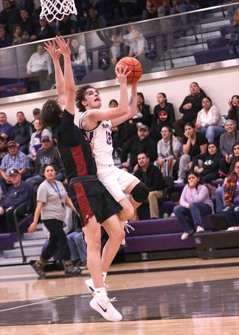 Polson  Pirate basketball player Jesse Vail goes in for a layup during a Feb. 8 home game against the Browning Indians.