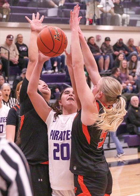 Ronan Maidens Nevaeh Perez and Lauryn Buhr put the squeeze on Polson Lady Pirate Ahri Rushing. The Maidens defeated the Lady Pirates 42-35.