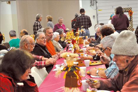 Community members share conversation over festive centerpieces.