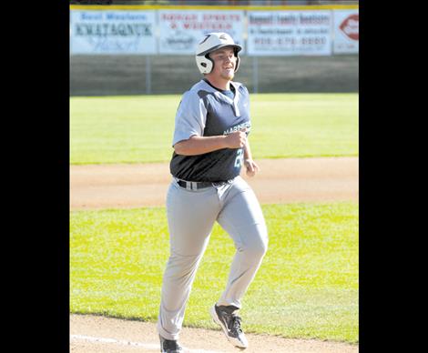 Micah McClure smiles as he trots home after knocking one out of the park.