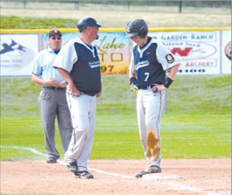 Coach Jami Hanson talks baserunning strategy with Warren Wood.