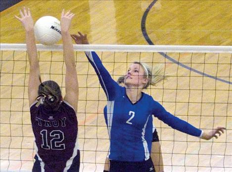 Loren Erickson tips the ball over the net during divisional play.