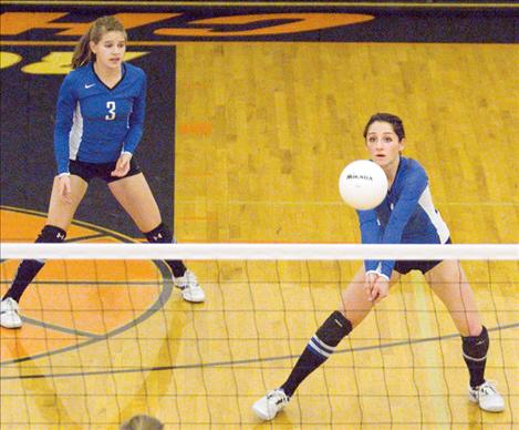 With Kaylie Durglo providing backup, Mission senior Sara Nerby returns the ball during a game at the divisional tournament. Nerby is one of four seniors leaving the team after the 2012 season.