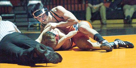 Left: Quentin Denton pins Noxon’s Gary Wadman after just 41 seconds in the first round of a home mixer  with Florence, Noxon and Deer Lodge Dec. 20. Denton went 2-0 on the night, pinning Florence’s Jace Pancake in 1:26 in round two.