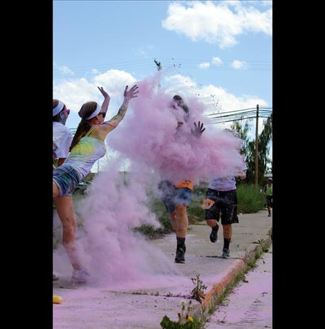 Olivia Clairmont retaliates by tossing a handful of pink cornstarch at friend Rylie Lindquist.